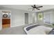 Bright bedroom featuring a large closet, neutral walls, carpeted floors, and an en-suite bathroom at 3570 E Arapahoe Pl, Centennial, CO 80122