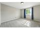 Neutral bedroom with a window featuring blue curtains and carpeted floor at 3570 E Arapahoe Pl, Centennial, CO 80122