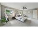 Spacious bedroom featuring two windows, neutral walls, carpeted floors, a ceiling fan, and an armchair at 3570 E Arapahoe Pl, Centennial, CO 80122
