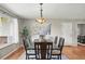 Bright dining room featuring hardwood floors, a large window, and a stylish chandelier at 3570 E Arapahoe Pl, Centennial, CO 80122