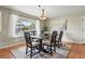 Elegant dining room with a modern chandelier, large window, and comfortable seating at 3570 E Arapahoe Pl, Centennial, CO 80122