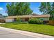 Charming ranch-style home featuring a well-manicured lawn and lovely curb appeal at 3570 E Arapahoe Pl, Centennial, CO 80122