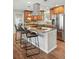 Kitchen island with granite countertops, bar stool seating, and stainless steel appliances at 3570 E Arapahoe Pl, Centennial, CO 80122