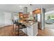 Spacious kitchen features an island with granite counters, stainless steel appliances, and wooden cabinets at 3570 E Arapahoe Pl, Centennial, CO 80122