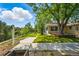 Well-manicured yard with lush lawn, mature trees, and a charming pathway leading to the home at 3570 E Arapahoe Pl, Centennial, CO 80122