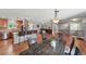 Open-concept kitchen and living room area with hardwood floors, fireplace, and lots of natural light at 3570 E Arapahoe Pl, Centennial, CO 80122