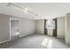 Spacious carpeted living room featuring track lighting and a window at 3570 E Arapahoe Pl, Centennial, CO 80122