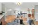 Spacious open-concept living area with hardwood floors, a kitchen bar, and dining space at 3570 E Arapahoe Pl, Centennial, CO 80122