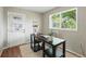 Cozy office featuring a dark wooden desk, neutral walls, a large window, and a door to the exterior at 3570 E Arapahoe Pl, Centennial, CO 80122