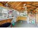 Organized shed interior with pegboard walls, shelves, and workbench area for projects and storage at 3570 E Arapahoe Pl, Centennial, CO 80122