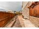 Side view of a brick backyard with nice landscaping and stone wall at 5597 S Buchanan St, Aurora, CO 80016