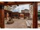 Backyard featuring a stone patio, a fire pit, and wooden outdoor seating areas at 5597 S Buchanan St, Aurora, CO 80016