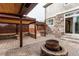 Spacious backyard with a stone patio, custom outdoor seating area and a fire pit at 5597 S Buchanan St, Aurora, CO 80016