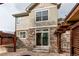 Backyard with a stone patio and a partially covered outdoor seating area at 5597 S Buchanan St, Aurora, CO 80016