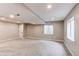 Finished basement offering a large recreational area with recessed lights and natural light from the window at 5597 S Buchanan St, Aurora, CO 80016