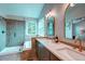 Luxurious bathroom with double sinks, framed mirrors, and a glass-enclosed shower, plus soaking tub at 5597 S Buchanan St, Aurora, CO 80016