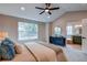 Bedroom features a ceiling fan and bathroom access with natural light through the window at 5597 S Buchanan St, Aurora, CO 80016