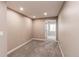 Cozy bedroom with neutral tones and plush carpeting, offers a peaceful retreat with ample natural light and a serene ambiance at 5597 S Buchanan St, Aurora, CO 80016