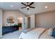 Bright bedroom showing bathroom access, closet access, vaulted ceiling and ceiling fan at 5597 S Buchanan St, Aurora, CO 80016