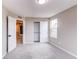 A bedroom featuring a sliding-door closet and a view into the hallway, showcasing a bright, open, and airy space at 5597 S Buchanan St, Aurora, CO 80016
