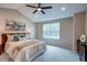 Bright bedroom featuring vaulted ceiling, ceiling fan, and a large window with natural light at 5597 S Buchanan St, Aurora, CO 80016