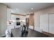 Dining area with modern white cabinetry, stainless appliances, and an eat-in kitchen at 5597 S Buchanan St, Aurora, CO 80016