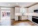Bright kitchen with white cabinets, stainless steel appliances, and access to the patio at 5597 S Buchanan St, Aurora, CO 80016