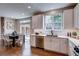 Bright kitchen with white cabinets, stainless steel appliances, and adjacent dining area at 5597 S Buchanan St, Aurora, CO 80016
