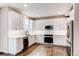 Stylish kitchen with white cabinetry, modern fixtures, and stainless steel refrigerator at 5597 S Buchanan St, Aurora, CO 80016