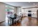 Modern kitchen and dining area featuring white cabinetry and stainless steel appliances at 5597 S Buchanan St, Aurora, CO 80016