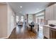 Open-concept living and dining areas feature hardwood floors, fireplace and natural light through sliding doors to the outside at 5597 S Buchanan St, Aurora, CO 80016