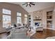 Cozy living room featuring vaulted ceiling, brick fireplace, and large windows at 5597 S Buchanan St, Aurora, CO 80016