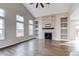 Bright living room with vaulted ceiling, fireplace, and hardwood floors at 5597 S Buchanan St, Aurora, CO 80016