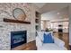 Living room featuring a stone fireplace and cozy armchair with blue pillow at 5597 S Buchanan St, Aurora, CO 80016