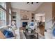 Open living room with fireplace, shelving, and an open floor plan to the dining area at 5597 S Buchanan St, Aurora, CO 80016