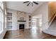 Inviting living room features a fireplace, built-in shelving, and hardwood floors at 5597 S Buchanan St, Aurora, CO 80016
