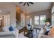 Inviting living room featuring staircase, many windows, and plush furniture at 5597 S Buchanan St, Aurora, CO 80016
