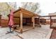 Covered wooden patio with seating and shade features in a backyard at 5597 S Buchanan St, Aurora, CO 80016