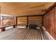 Covered wooden patio with a built-in bench and storage unit at 5597 S Buchanan St, Aurora, CO 80016