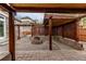 Outdoor patio area with pavers, covered structures, stone seat, and a fire pit at 5597 S Buchanan St, Aurora, CO 80016