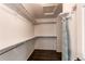 Spacious walk-in closet featuring custom shelving, wood floors, and ample storage space at 5597 S Buchanan St, Aurora, CO 80016