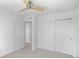 Bedroom with neutral carpeting, ceiling fan, and closets at 701 N Roslyn St # 36, Denver, CO 80230