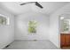 Cozy bedroom with vaulted ceiling, ceiling fan, and large window overlooking the lush surroundings at 701 N Roslyn St # 36, Denver, CO 80230