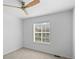 Bedroom with neutral carpeting, ceiling fan, and large window at 701 N Roslyn St # 36, Denver, CO 80230