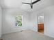 Bright bedroom featuring a ceiling fan, large window, and ensuite bathroom at 701 N Roslyn St # 36, Denver, CO 80230