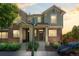 Inviting two-story townhome with brick and stucco exterior under a beautiful sunset at 701 N Roslyn St # 36, Denver, CO 80230