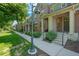 Street view of attractive townhomes with well-maintained landscaping and walkways at 701 N Roslyn St # 36, Denver, CO 80230