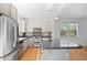 Open kitchen with stainless steel appliances and center island for entertaining at 701 N Roslyn St # 36, Denver, CO 80230