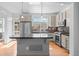 Well-lit kitchen featuring stainless steel appliances, stone countertops, and center island at 701 N Roslyn St # 36, Denver, CO 80230