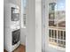 Bright laundry room with washer, dryer, and access to outdoor deck at 701 N Roslyn St # 36, Denver, CO 80230